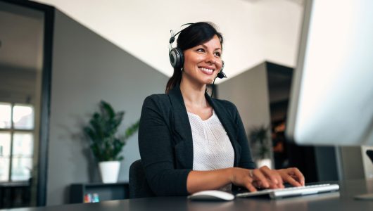 Close-up image of happy woman with headset.